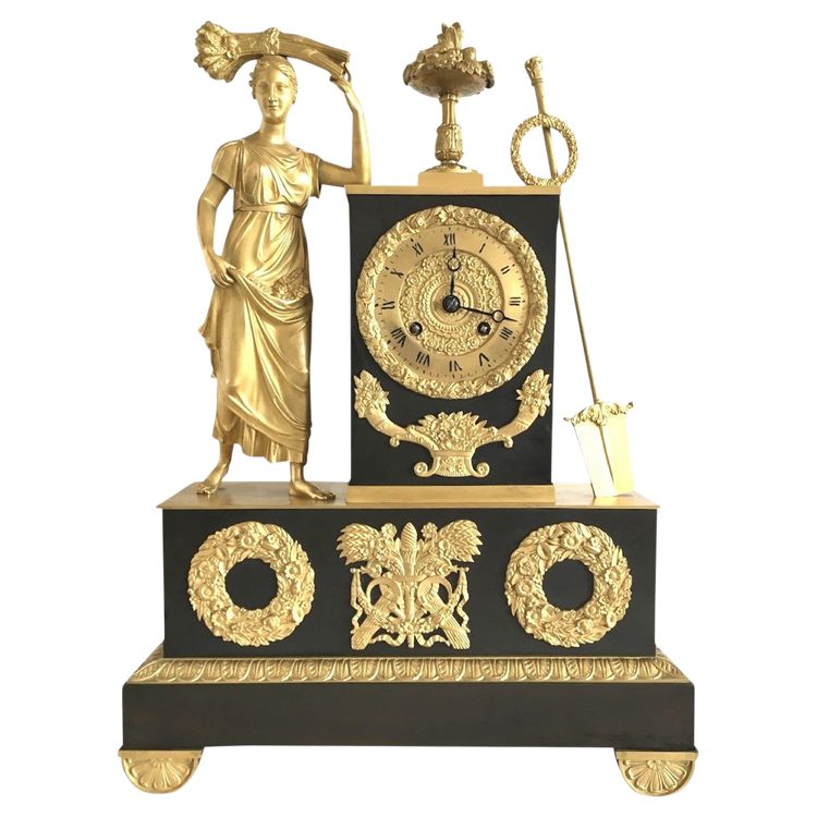 Pendule en bronze doré et patiné, 19ème d'époque Restauration